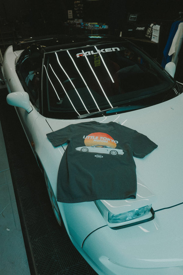 An NSX-R in the shop with a BOWLS tee on the hood