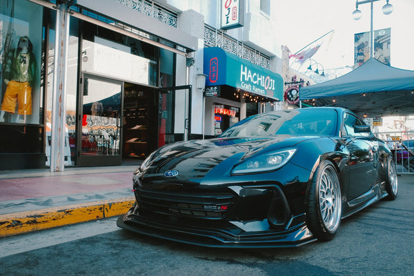 A black GR86 parked outside the shop
